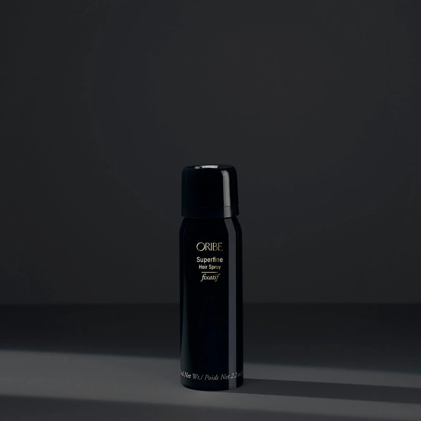 Black Oribe hair product bottle on a dark background