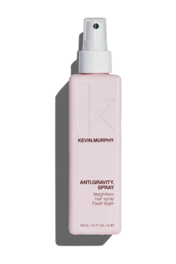 A pink spray bottle of Kevin Murphy Anti Gravity Spray for hair styling.