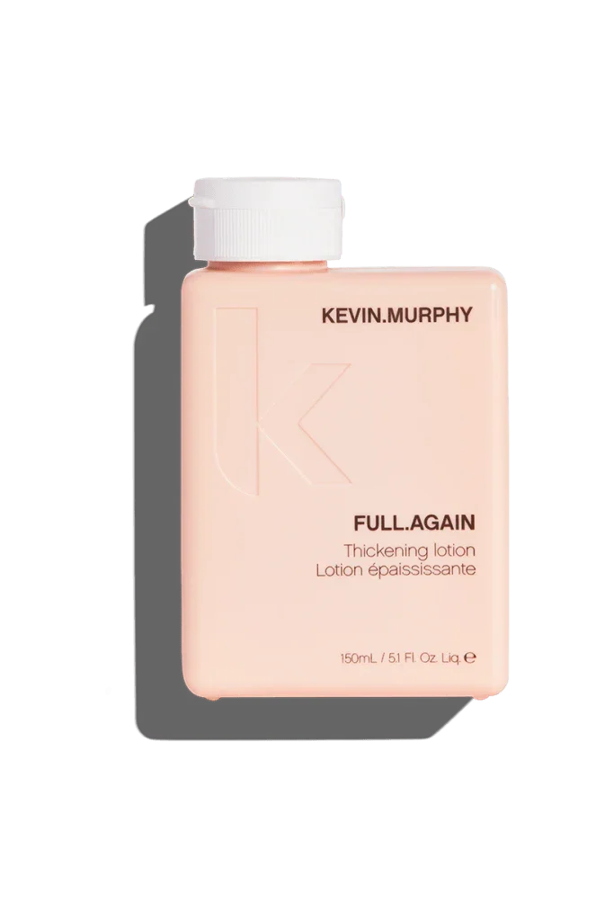 A bottle of Kevin Murphy Full.Again Thickening Lotion, with pink and white labeling, against a green background.
