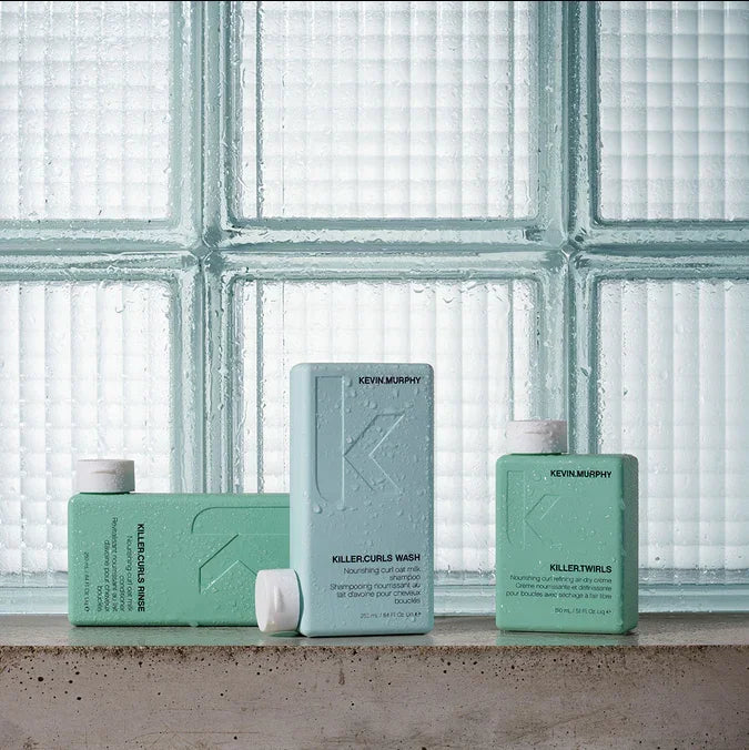 Kevin Murphy Shampoos on cement shelf and glass cubes behind