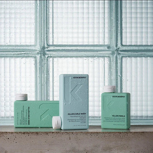 Kevin Murphy Shampoos on cement shelf and glass cubes behind
