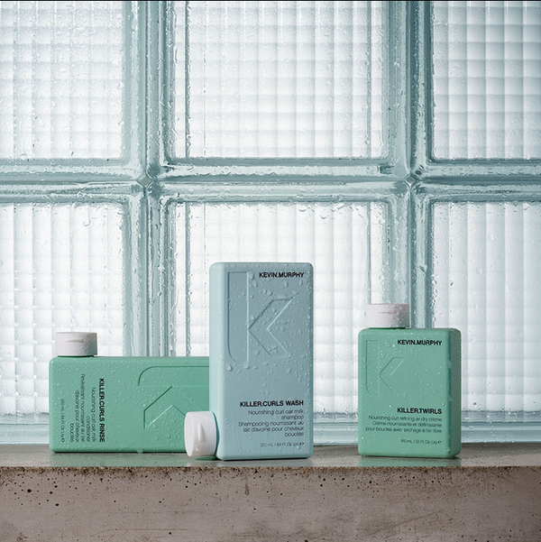Kevin Murphy Shampoos on cement shelf and glass cubes behind