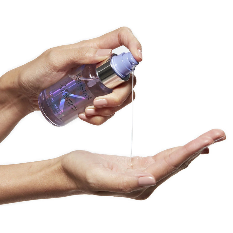 Hand holding a bottle of Lavera Tagespflege face and body lotion, dispensing product onto the palm.