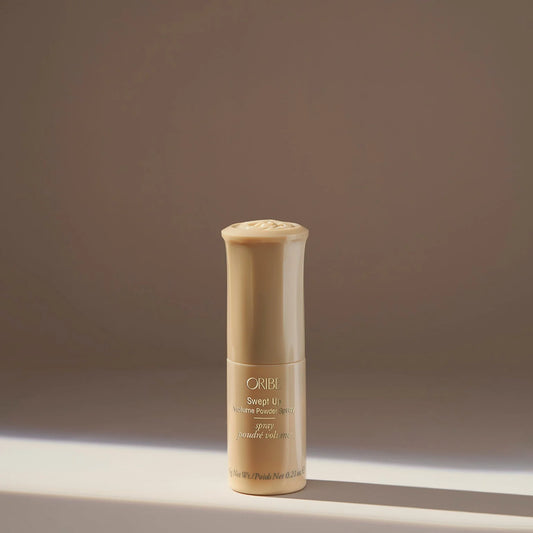 Oribe hair product bottle on a neutral background