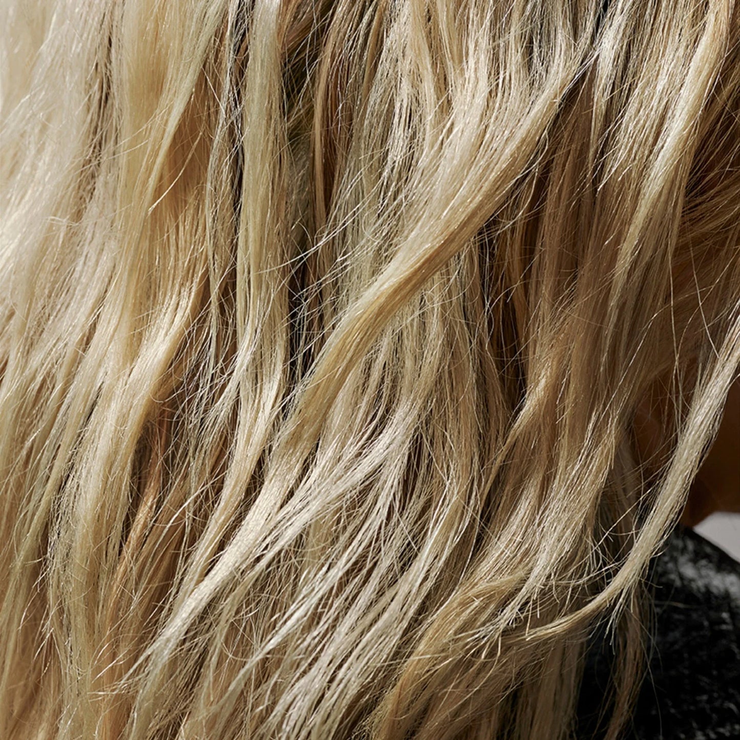 Close-up of blonde hair with a blurred background