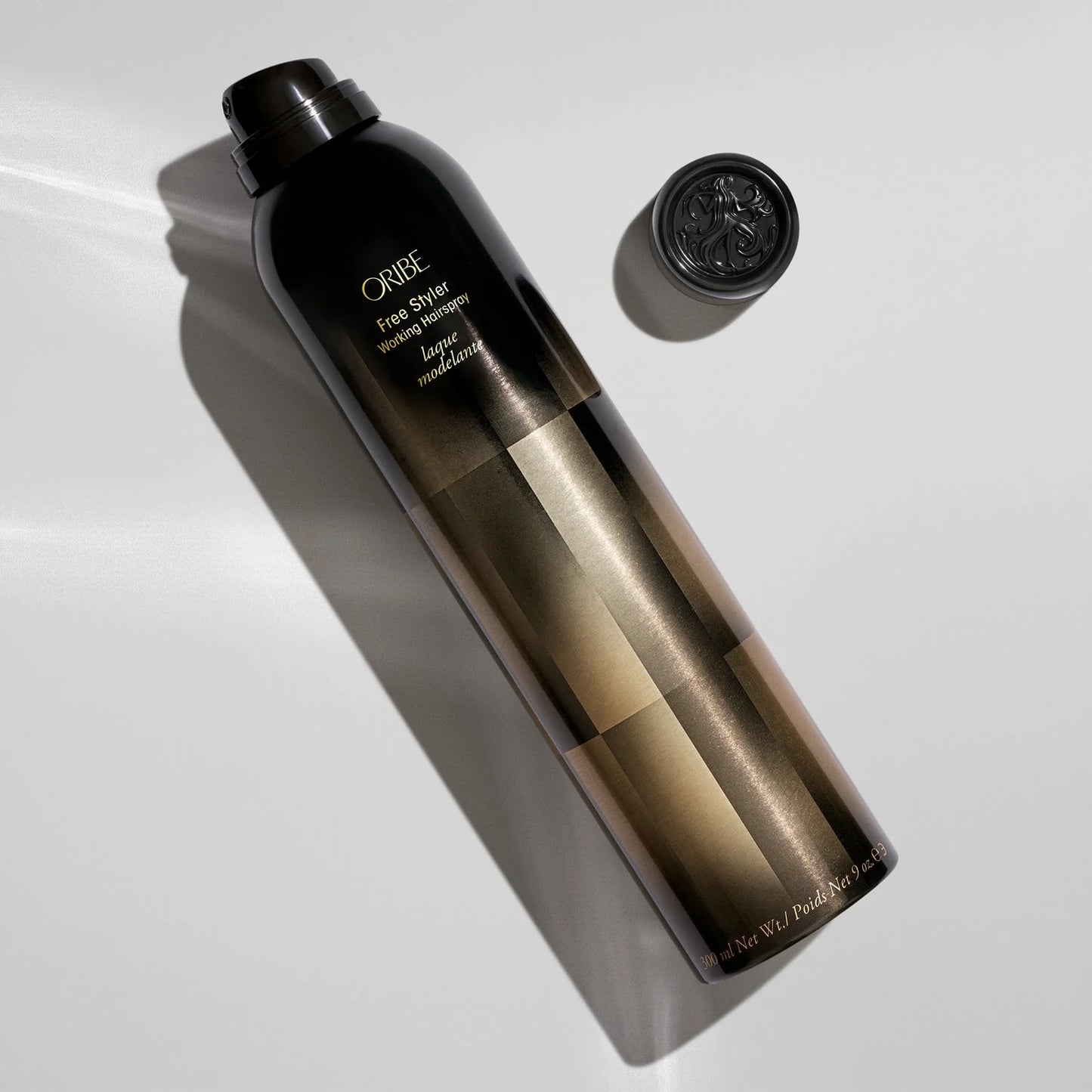 Oribe hair product bottle on a white background