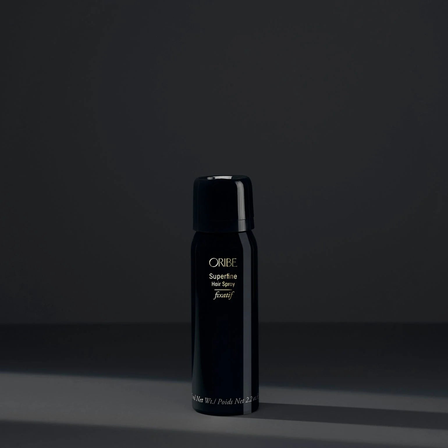 Black Oribe hair product bottle on a dark background