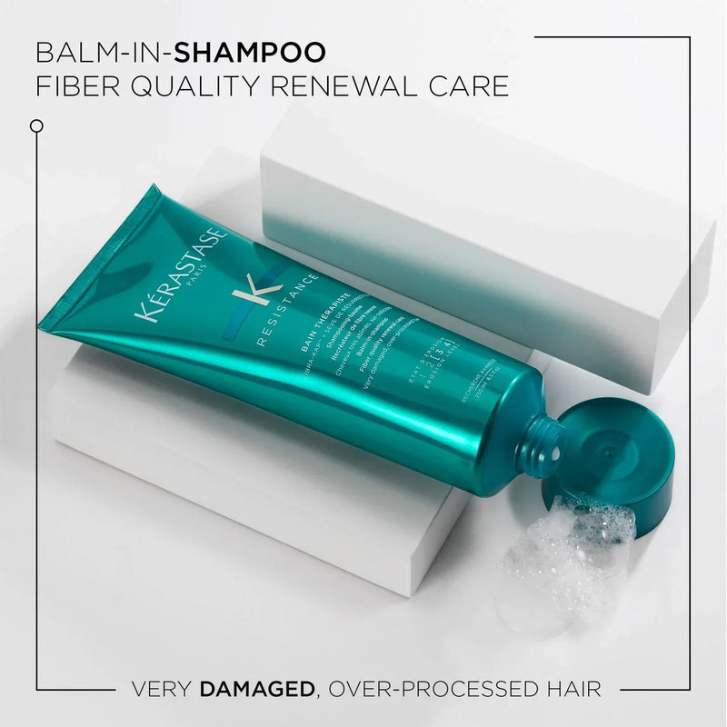 Kerastase balm-in-shampoo tube with shampoo being dispensed on a white background