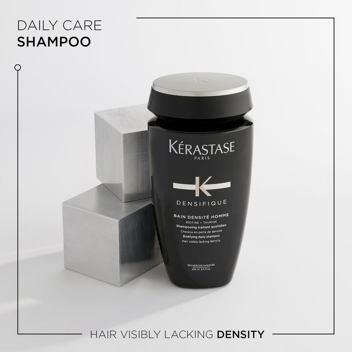 Kérastase shampoo bottle with metallic cubes on a light gray background