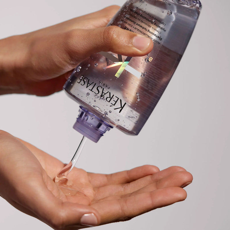 Kerastase Bain Lumiere Bottle being squeezed onto hand