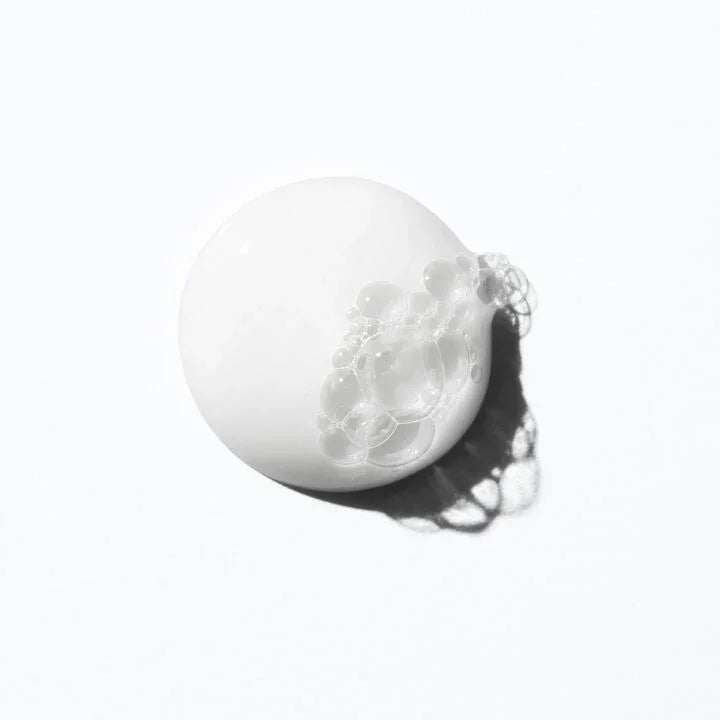 White spherical object with a textured surface on a white background