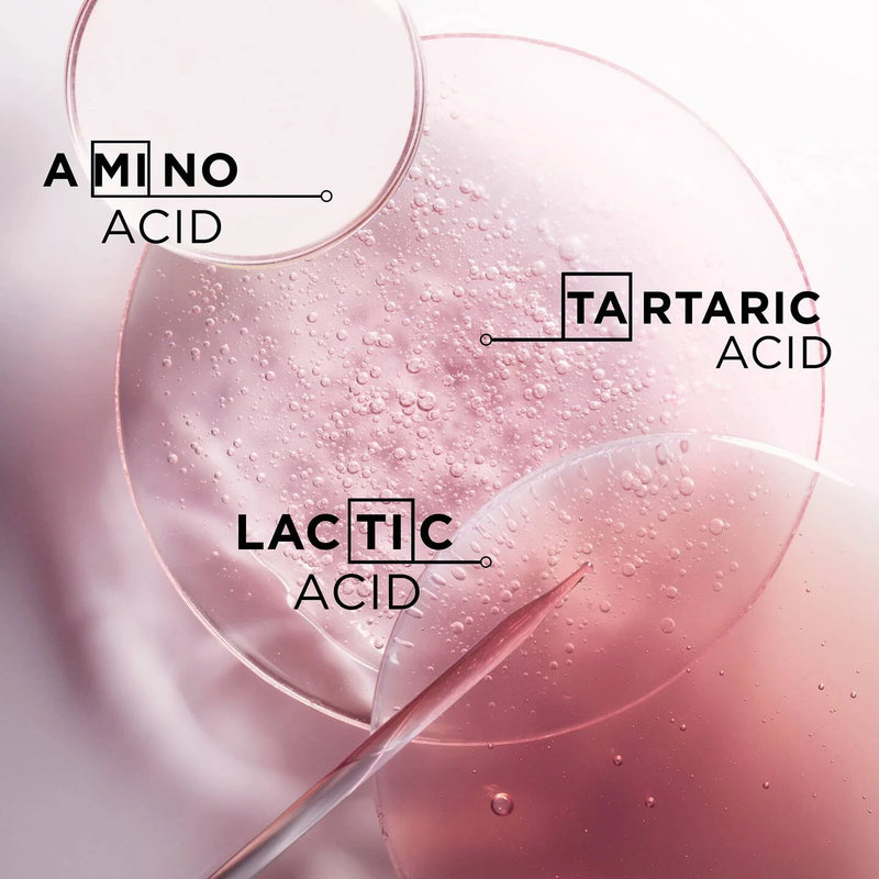 Pink liquid with text labels for amino acid, tartaric acid, and lactic acid on a light pink background.