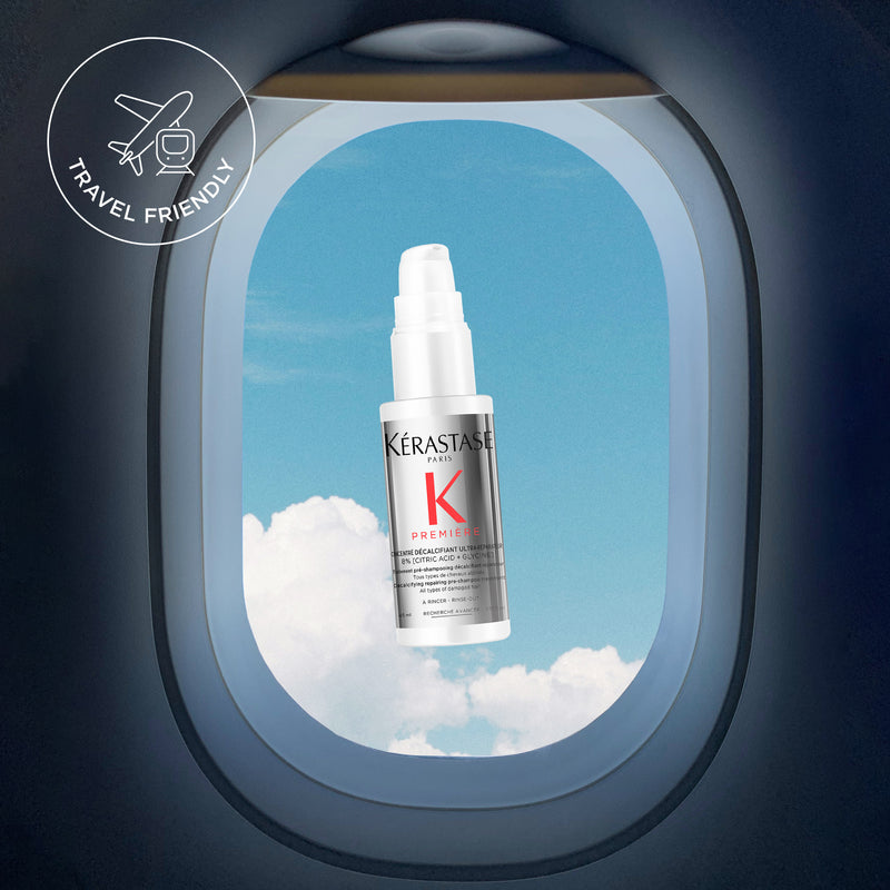 Travel size Kerastase product from a window plane with clouds and sky background