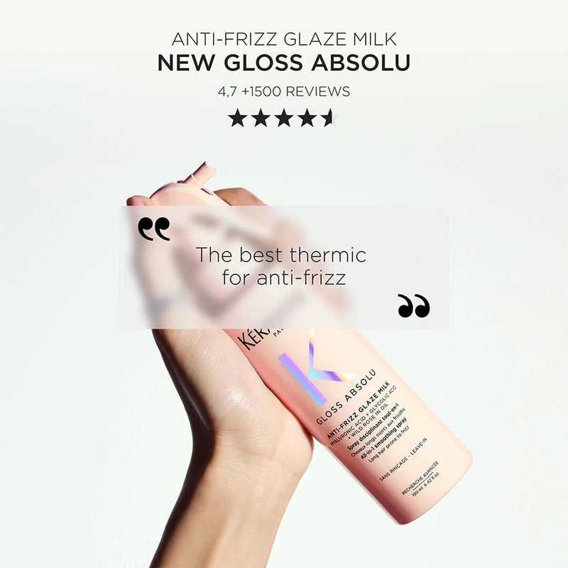 Kerastase Gloss Absolu Anti-Frizz Glaze Milk bottle with hand holding it on a white background
