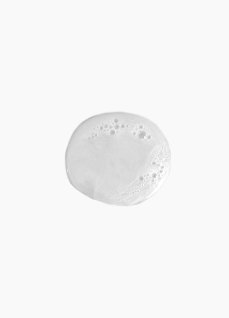 Round white plate with bubbles on a white background