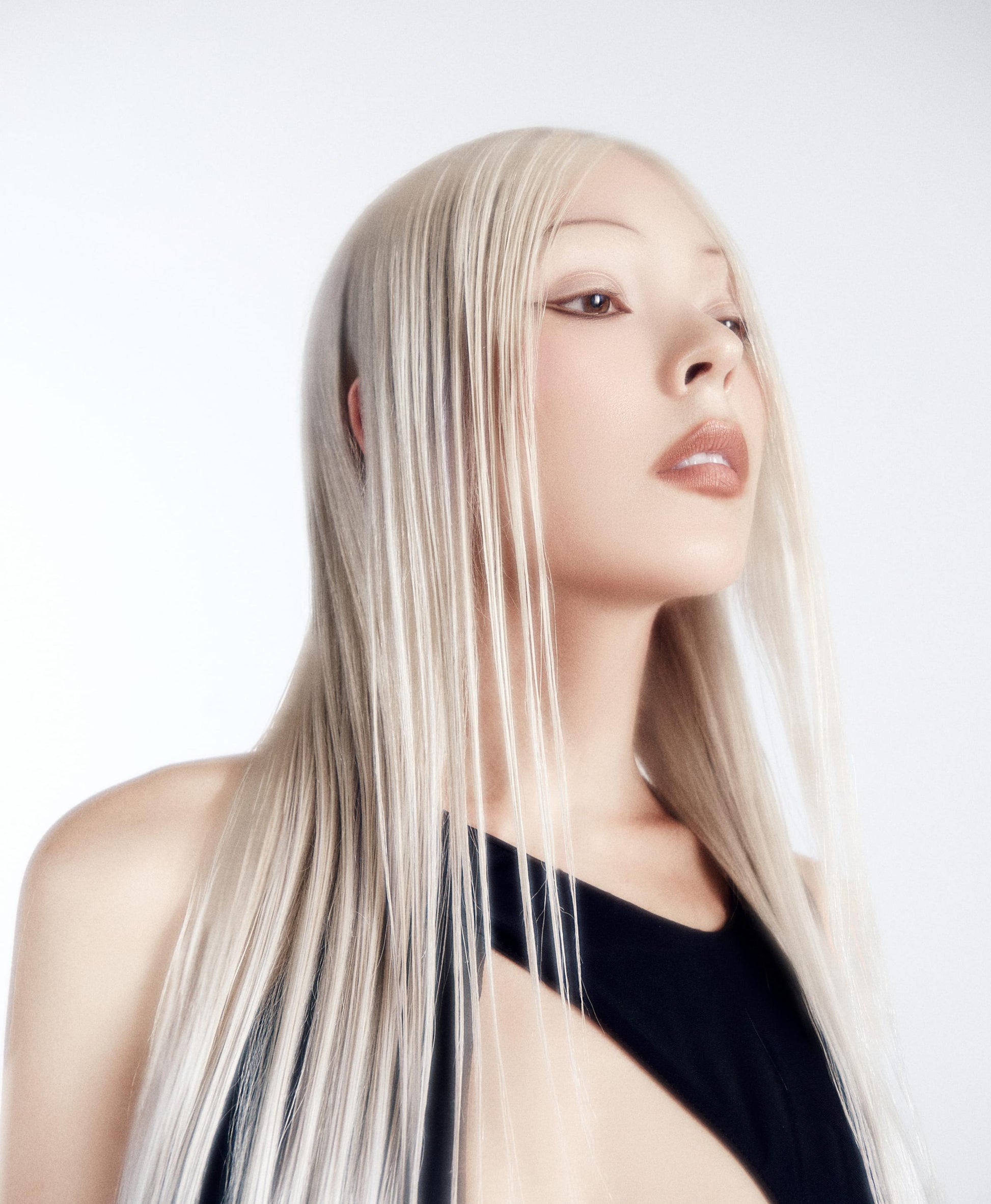 Woman with long, straight blonde hair against a white background