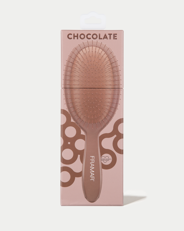 Hairbrush with packaging labeled 'Chocolate' by Framar on a light pink background