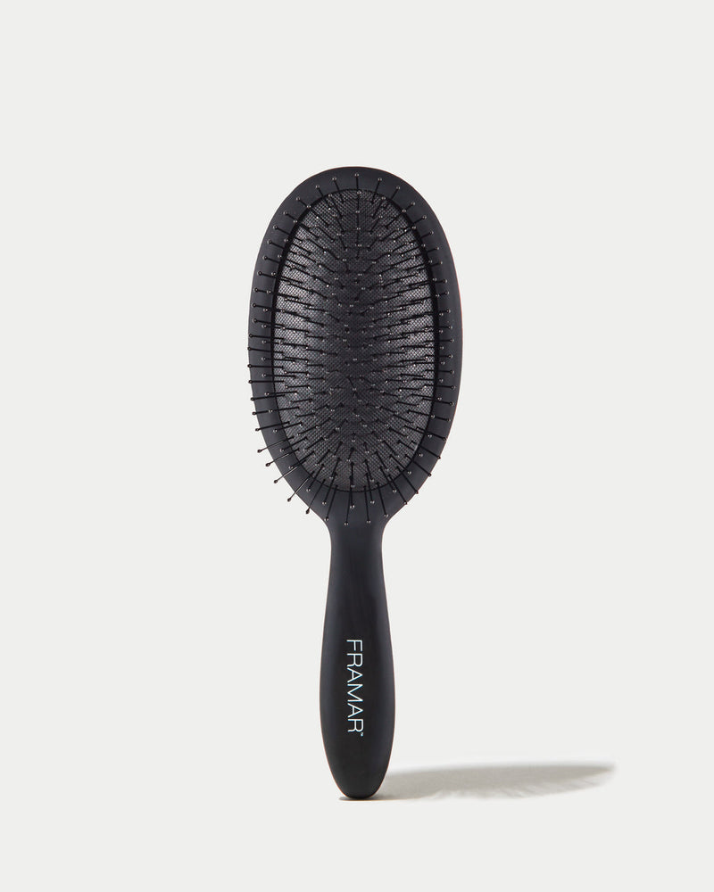 Black hairbrush with 'Framar' branding on a white background
