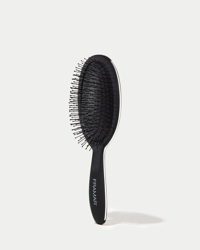 Black hairbrush with 'Framar' branding on a white background