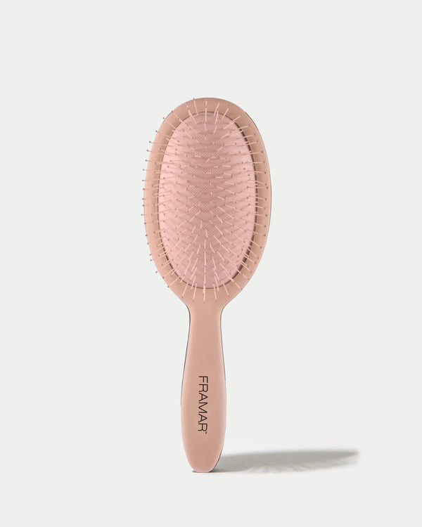 Pink hairbrush with 'Framar' branding on a white background