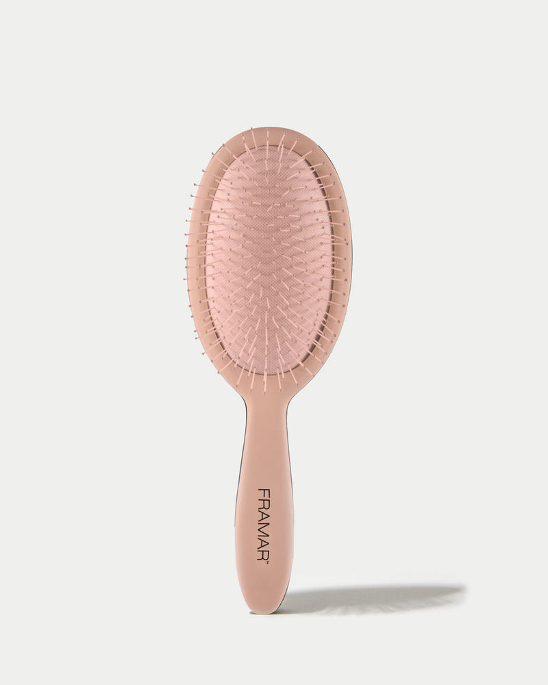 Pink hairbrush with 'Framar' branding on a white background