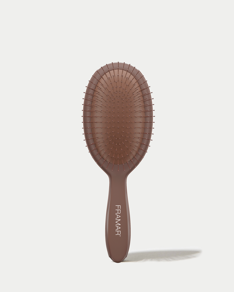 Brown hairbrush with 'Flemar' branding on a white background