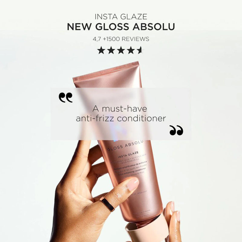 Hand holding a pink bottle labeled 'Gloss Absolu' with text about the product on a light gray background.