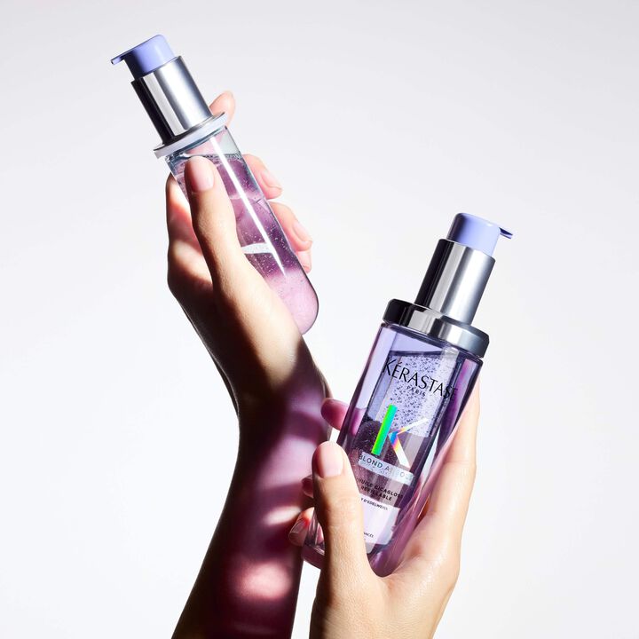 Two bottles of NERASTAR hair care product held by a hand against a light background