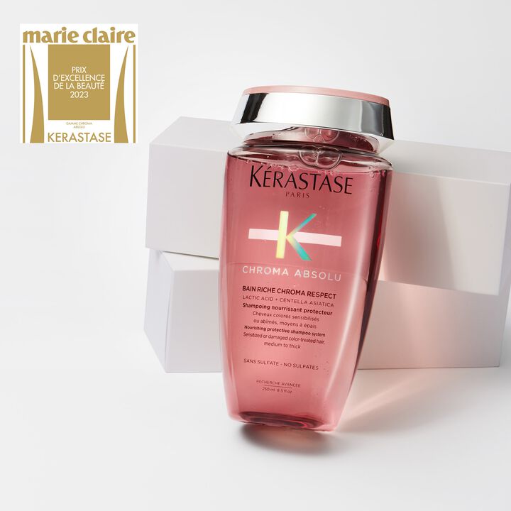 Kerastase Chroma Absolu shampoo bottle with a white box on a light gray background, featuring the Marie Claire Prix d'Excellence de la Beaute 2021 award.