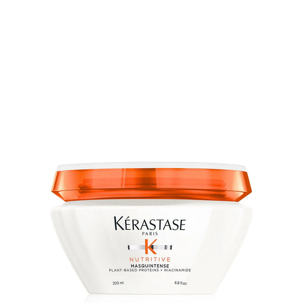 Kérastase hair mask jar with orange lid on a white background