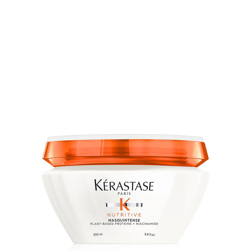 Kérastase hair mask jar with orange lid on a white background