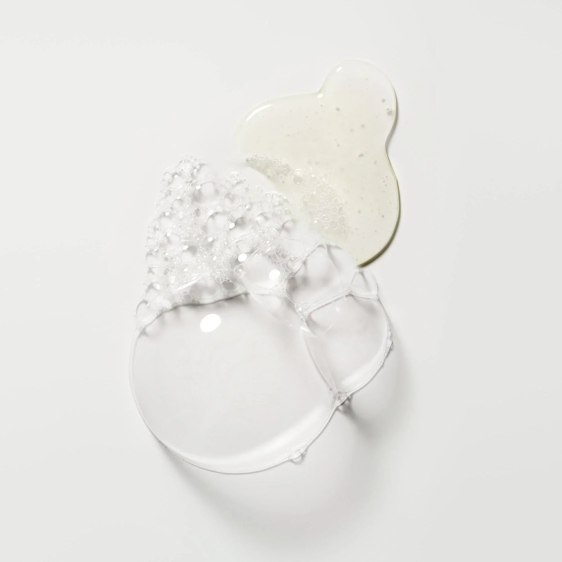 Clear glass bowl with a decorative white lid on a light gray background