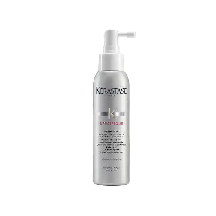 Kérastase hair care product bottle on a white background