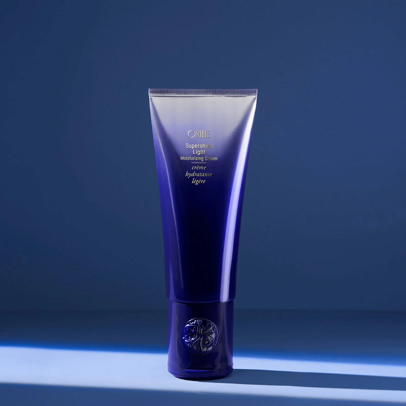 Blue cosmetic tube with brand logo on a blue background
