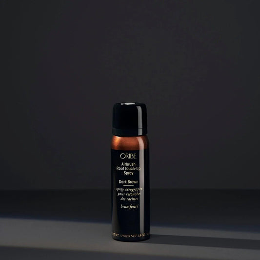 A spray bottle of Oribe Airbrush Root Touch-Up Spray in Dark Brown, designed for covering greys and roots or refreshing highlights.