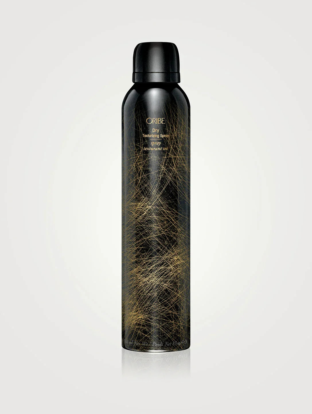 A can of ORIBE Dry Texturizing Spray with a black and gold design on a white background.