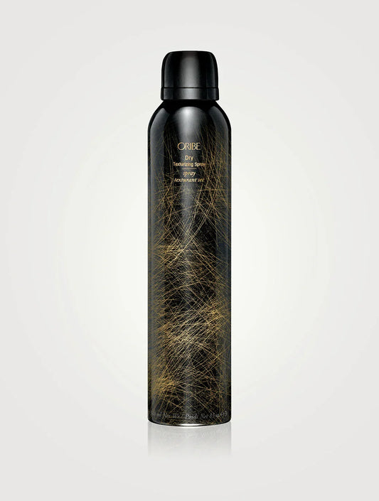 A can of ORIBE Dry Texturizing Spray with a black and gold design on a white background.