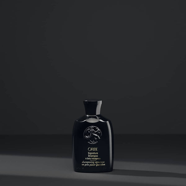 Oribe signature shampoo travel size black background