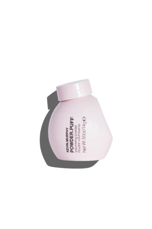 A small white jar labeled 'POWDER.PUFF' by Kevin Murphy designed for creating instant volume and texture in hair.