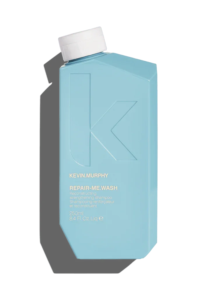 A blue bottle of Kevin Murphy Repair-Me.Wash Shampoo.