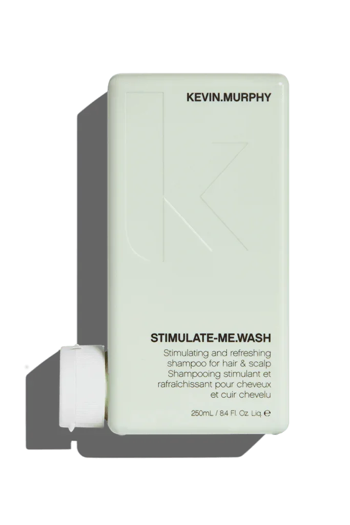 A 250 ml bottle of Kevin Murphy Stimulate.Me Wash Shampoo with product information and branding visible.