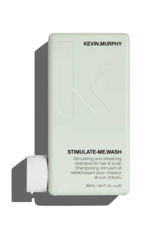 A 250 ml bottle of Kevin Murphy Stimulate.Me Wash Shampoo with product information and branding visible.