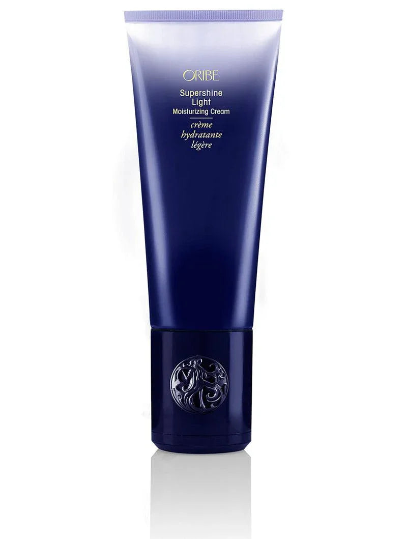 A tube of ORIBE Supershine Light Moisturizing Cream with dark blue packaging.